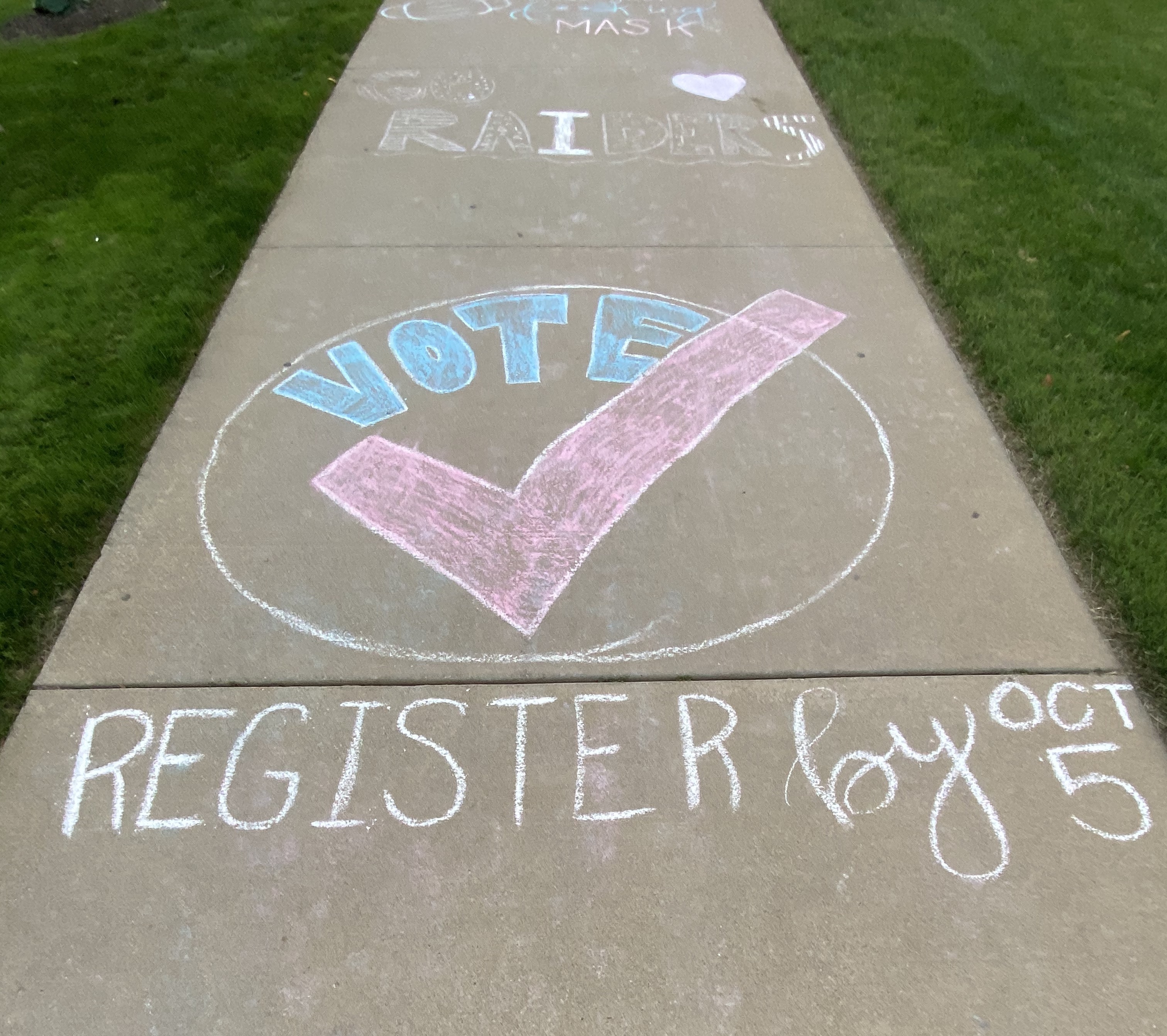voting graphic drawn on sidewalk in chalk