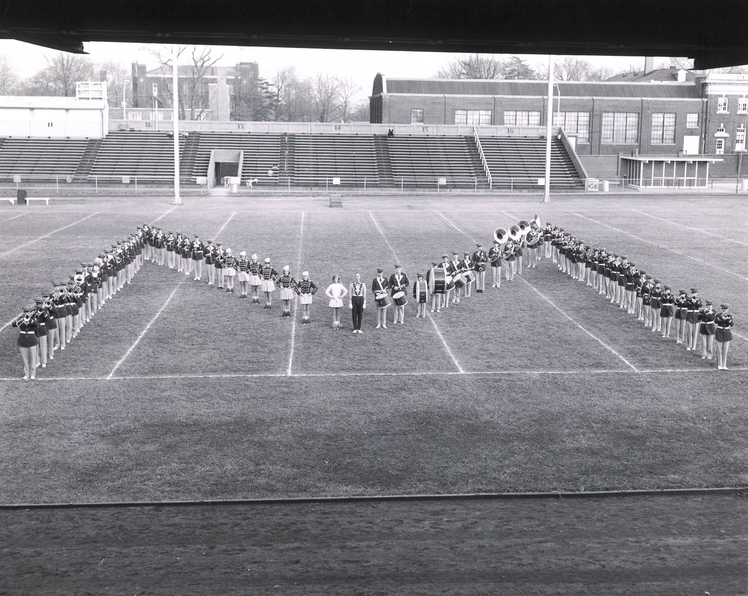 marching band forming an "M" in black and white photo