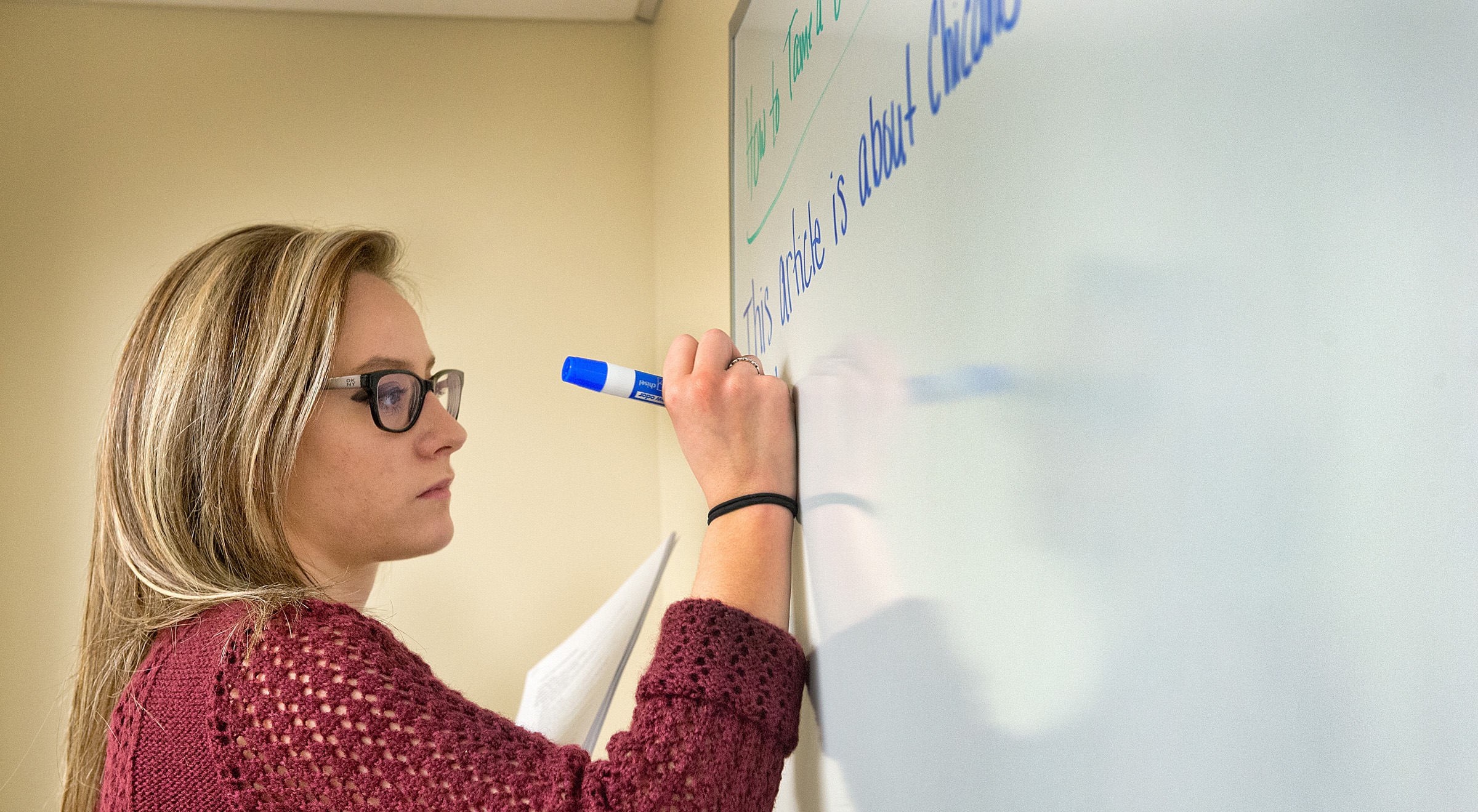 University of Mount Union student writing on a whiteboard 