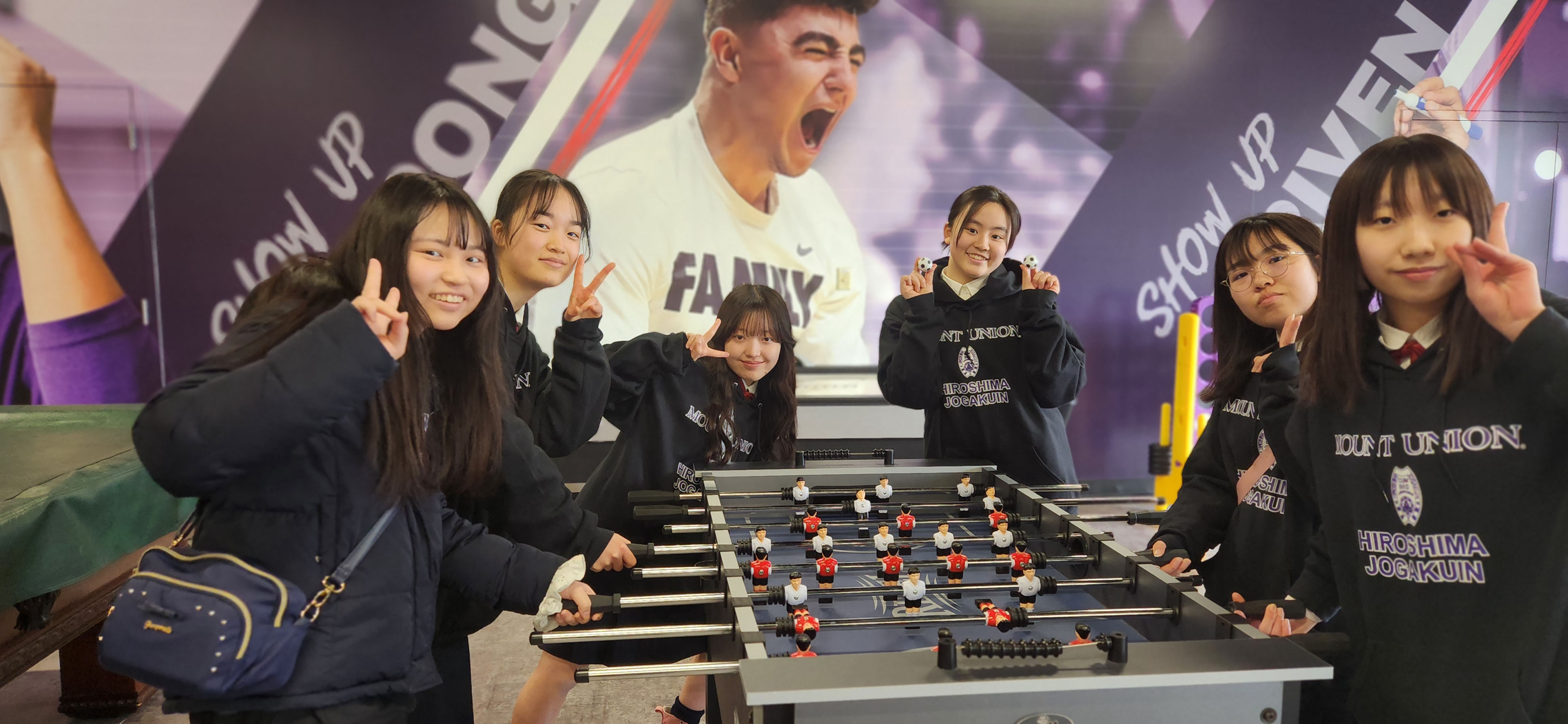 Visiting students playing foosball