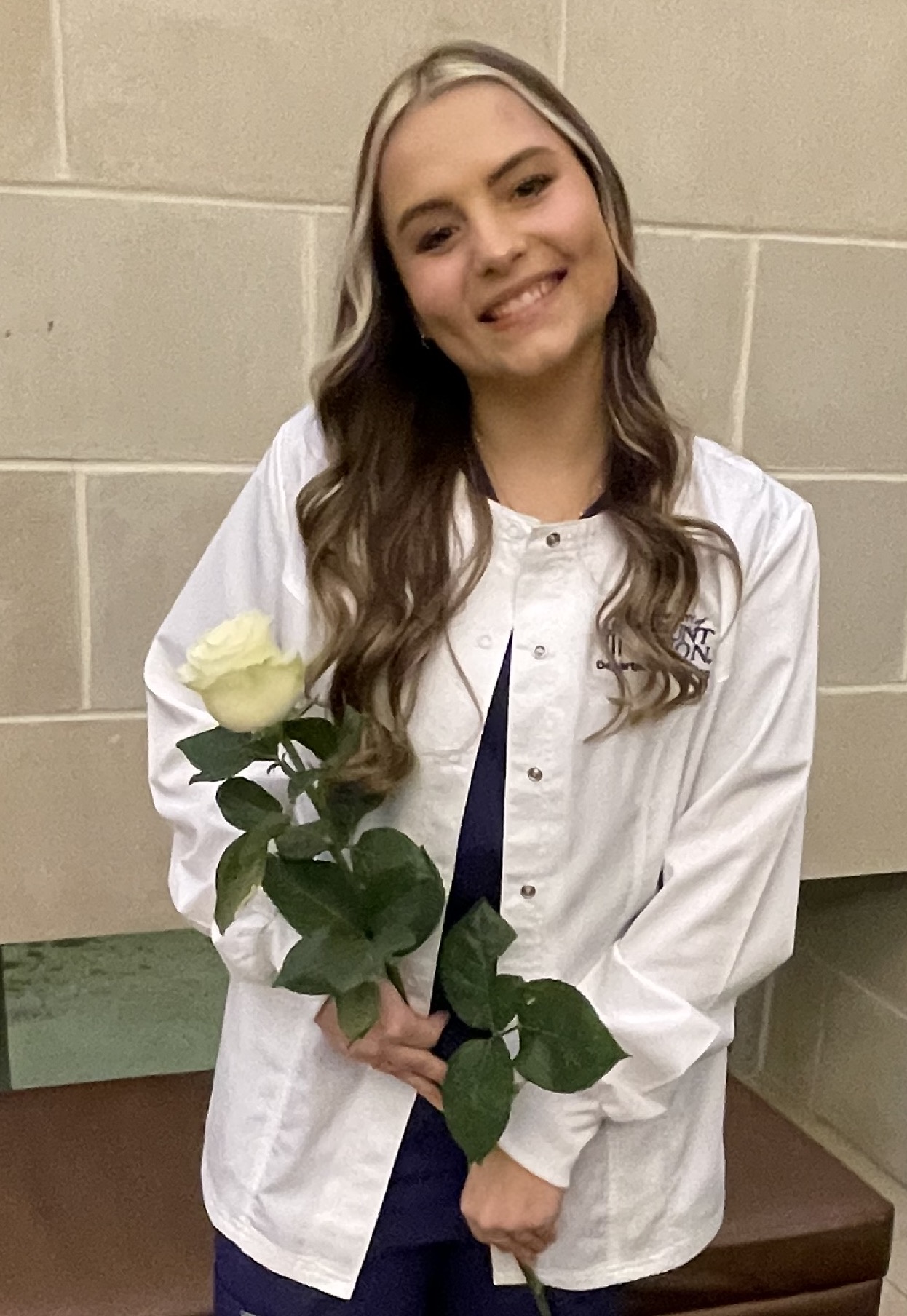Graffice '25, nursing student receiving white coat