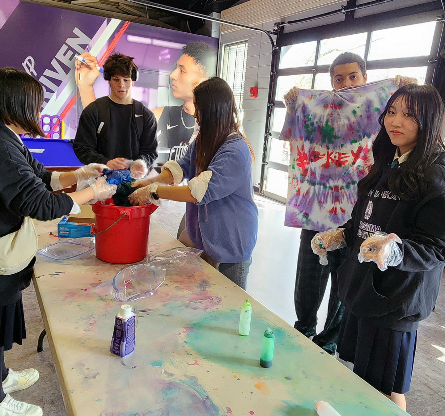 Visiting students tie dying shirts with Mount Union students