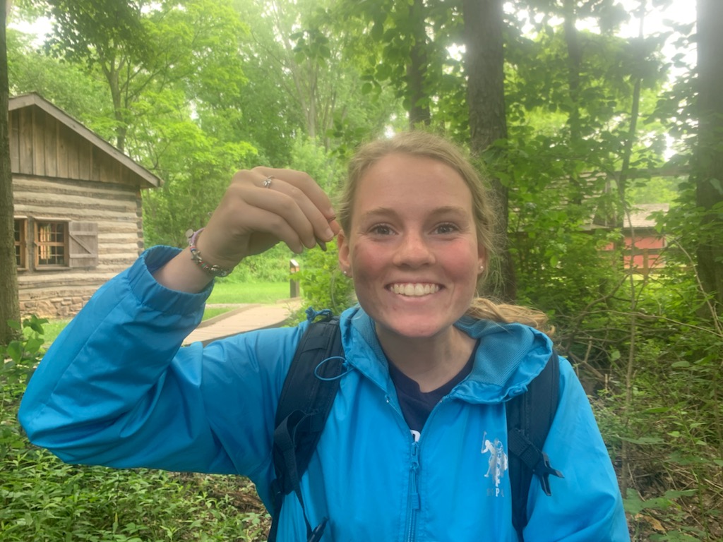 girl smiling holding worm