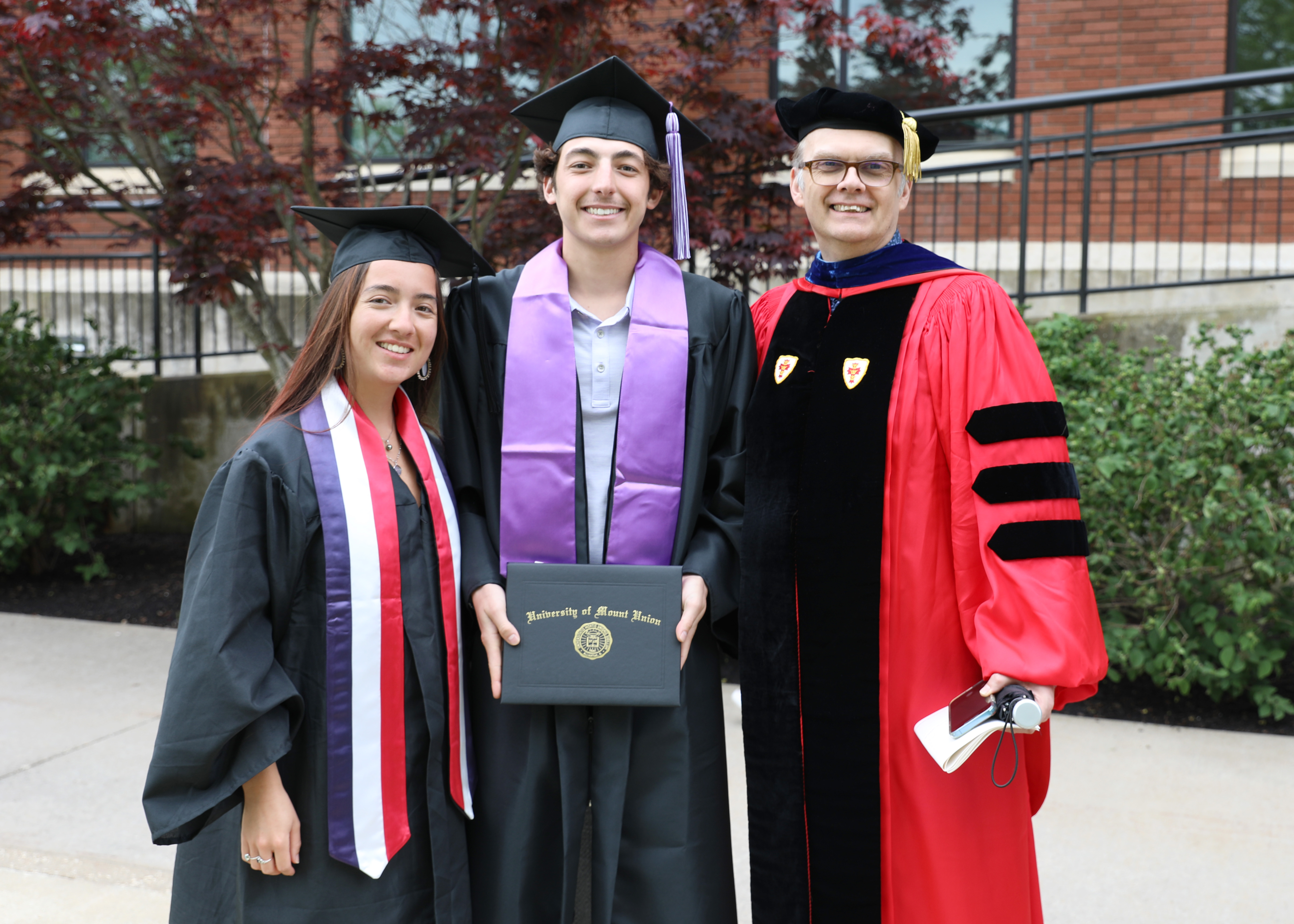 Students and a faculty member at the 2023 Mount Union commencement ceremony.
