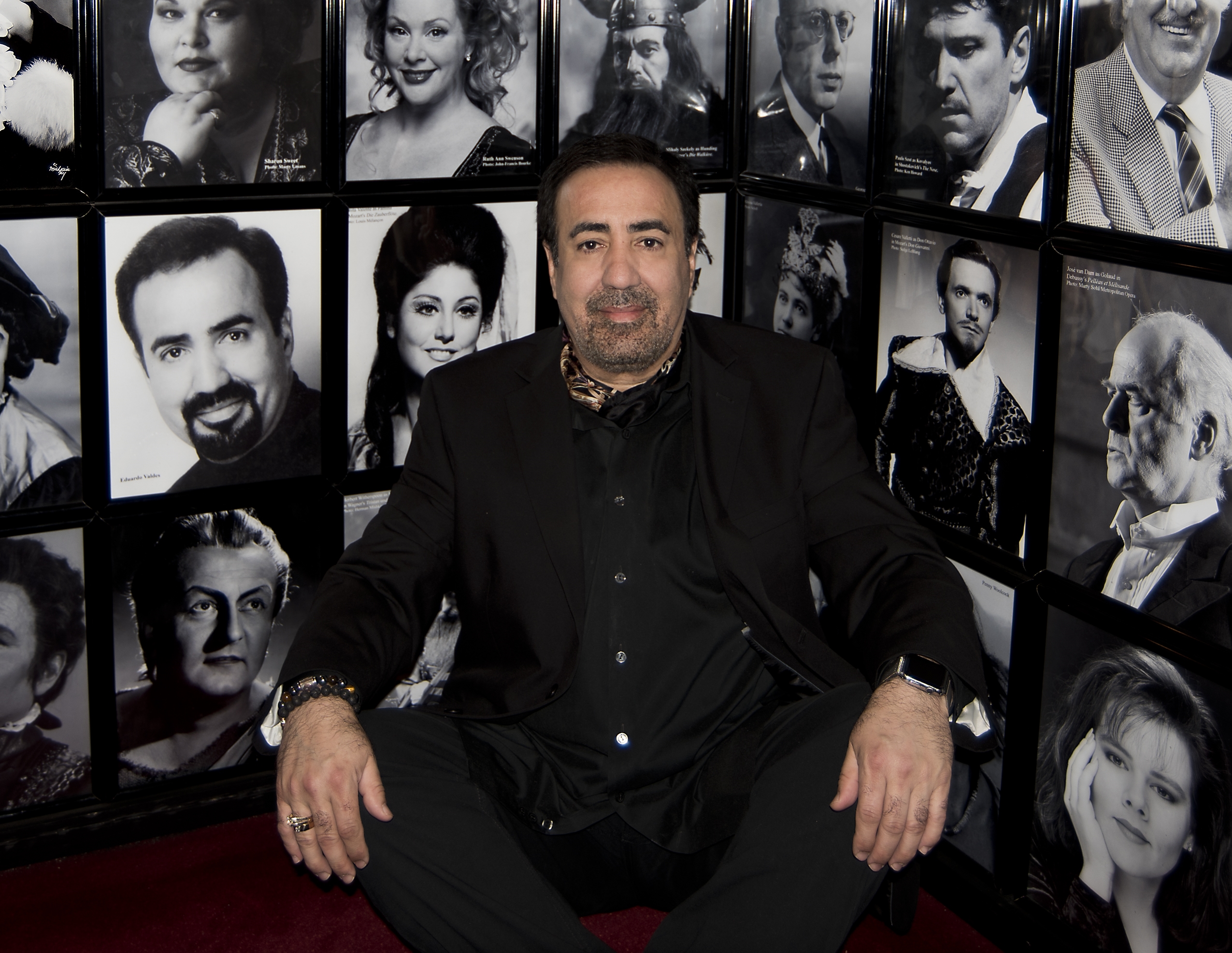 Eduardo Valdes in front of wall of musician photos