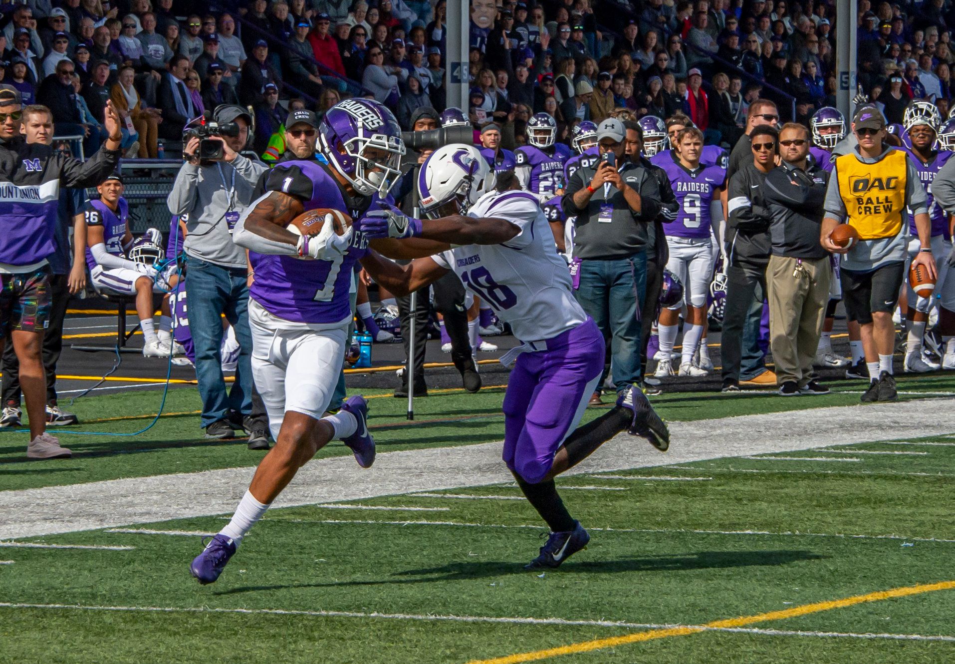 football player with stiff arm