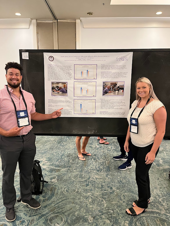 Jessica Knicely and Justin Sturgill pose in front of their research poster