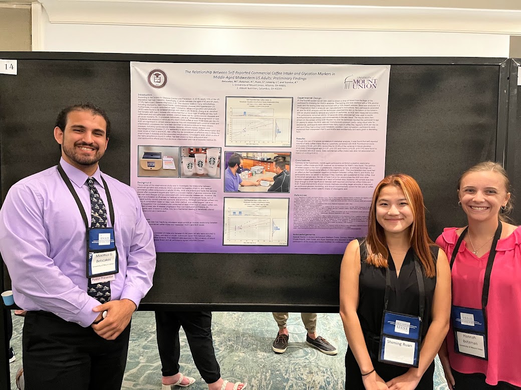 Maximus Betscakos, Hannah Botzman, and Shiming Ruan pose in front of their research poster