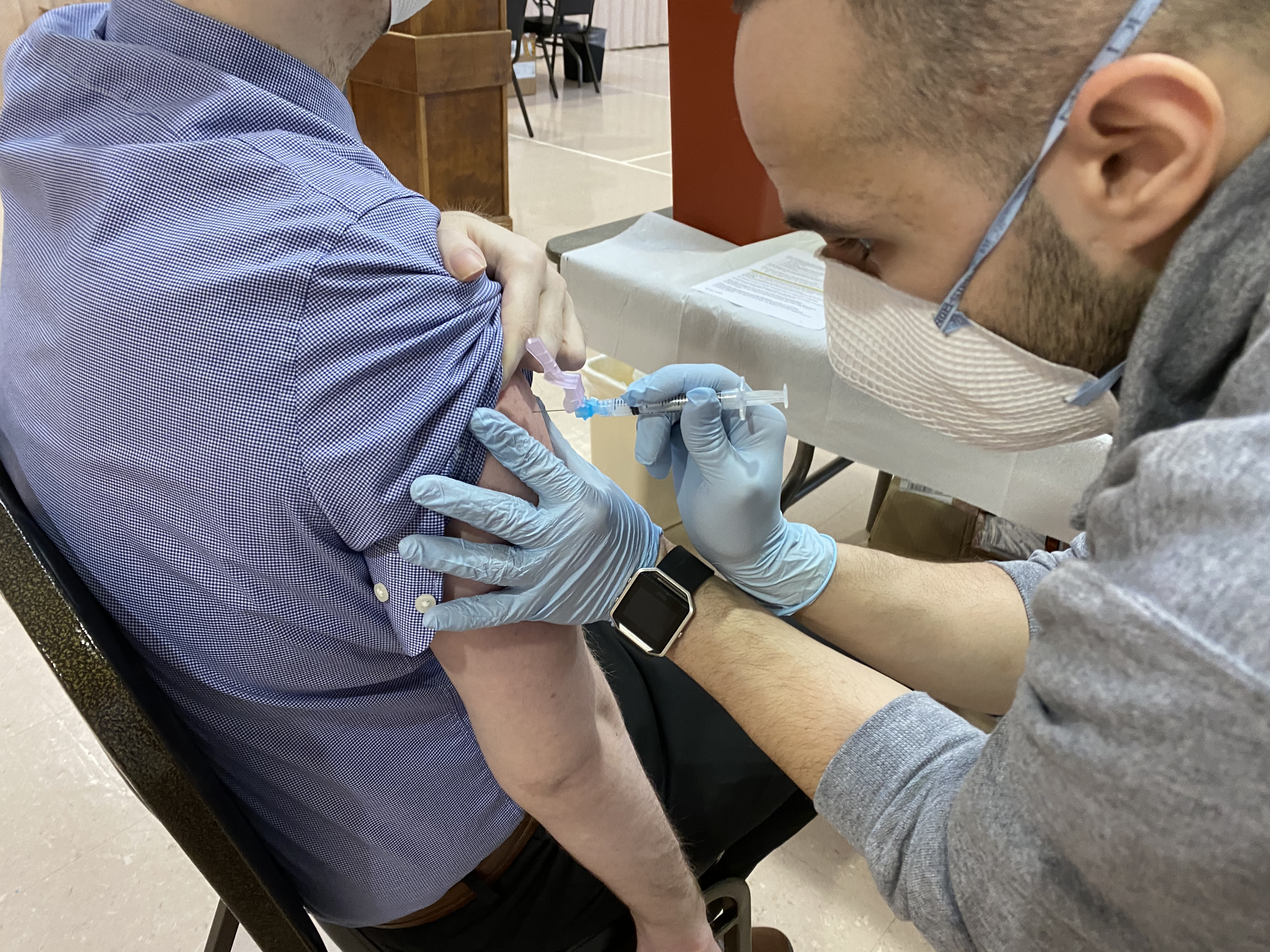 man injecting vaccine