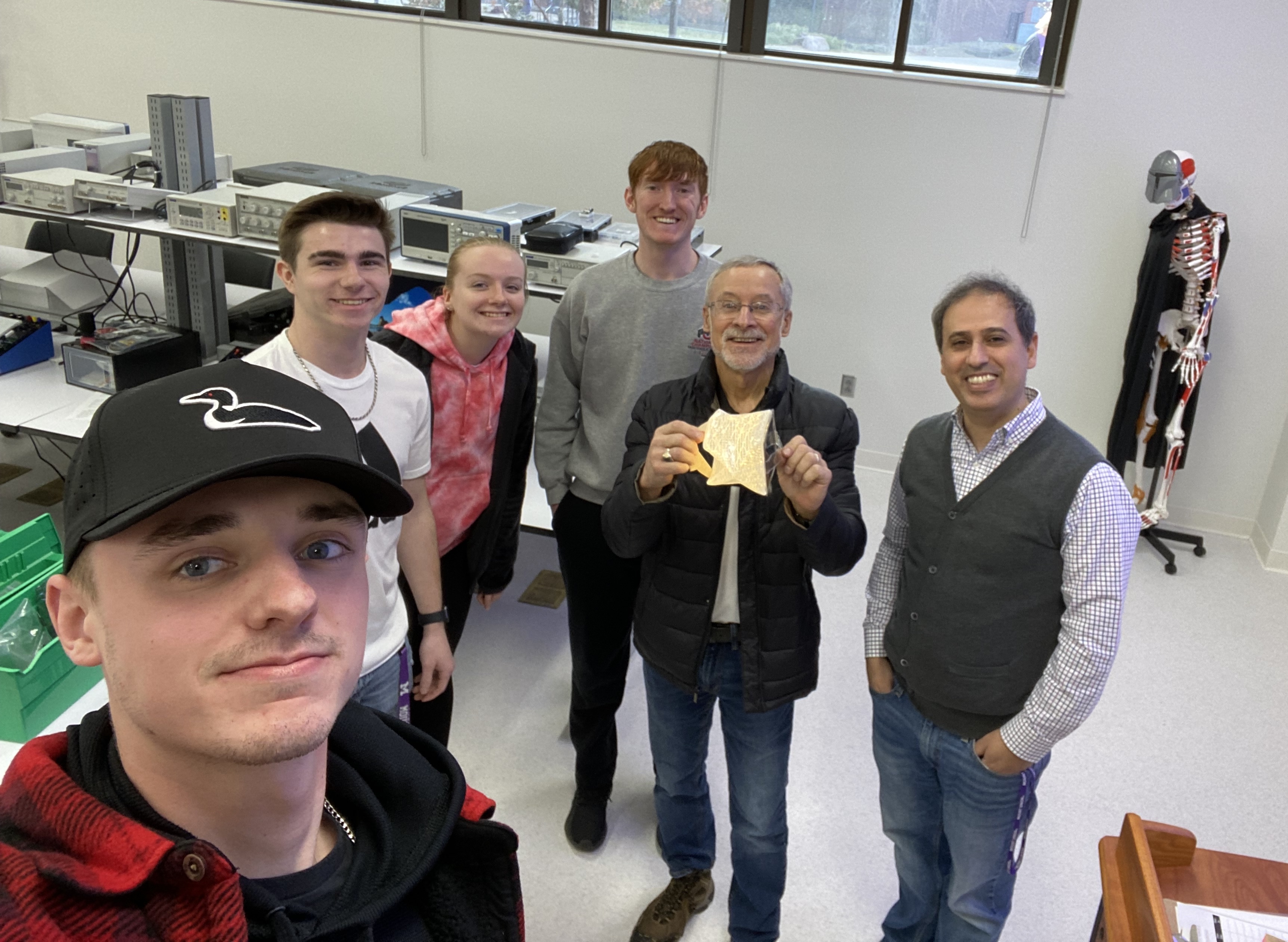 edwards holding item standing with group