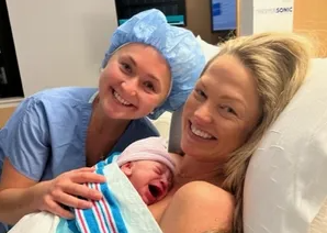 laforce sisters sitting in hospital bed with newborn