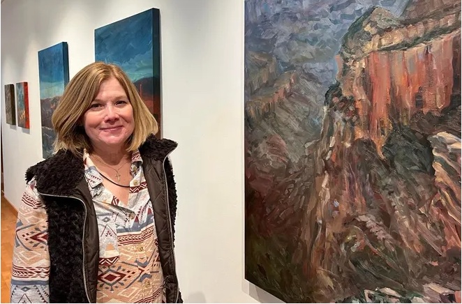 margo miller standing in front of painting