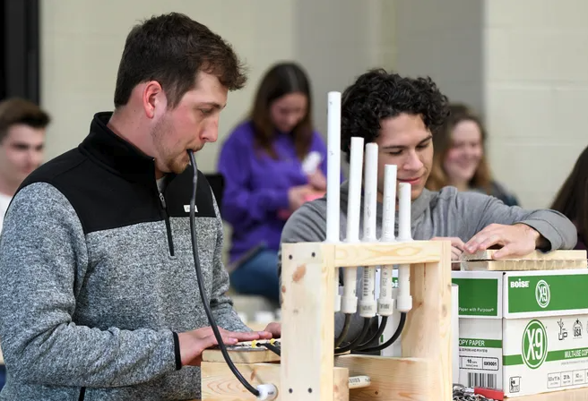 students performing on homemade instruments