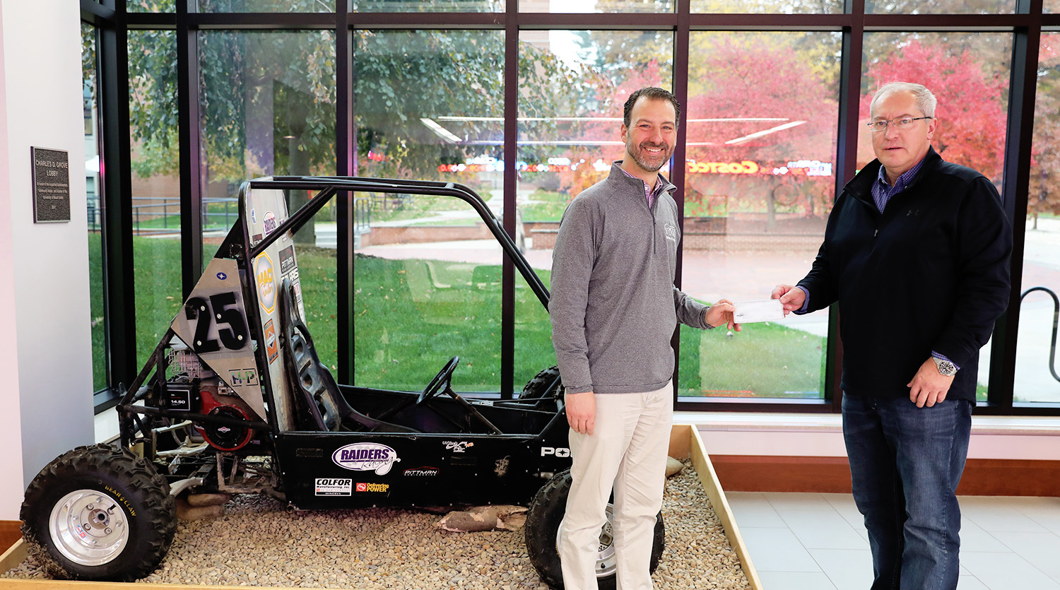 pittman and korach standing next to baja car