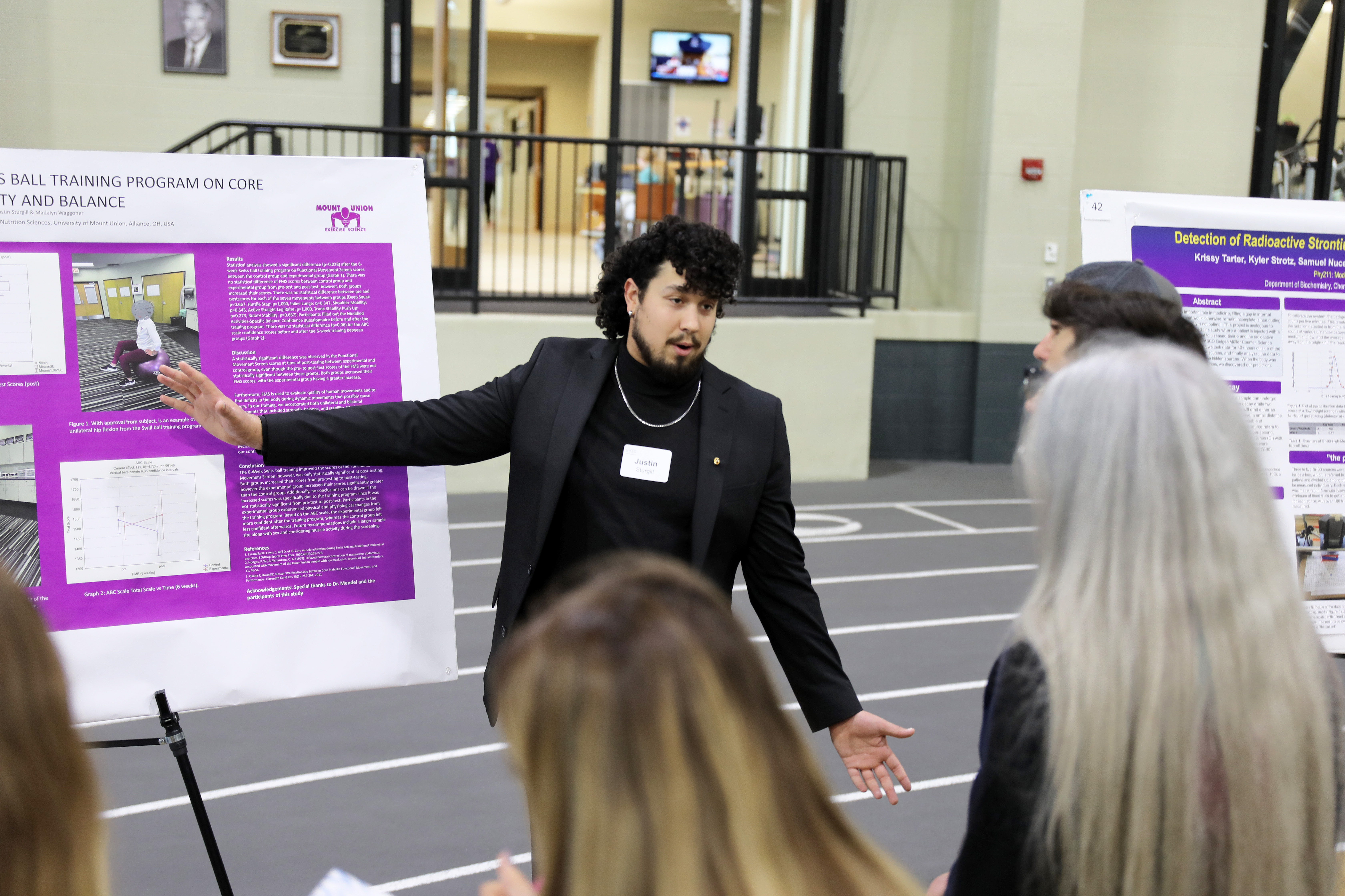 student pointing at poster
