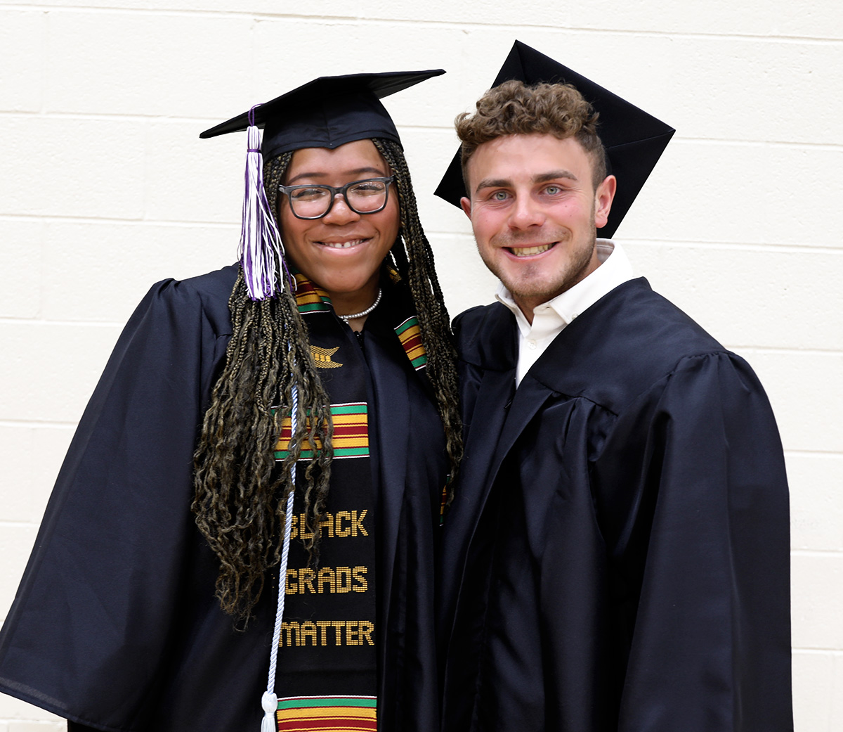 aaliyah kinnard and braydon lazzara in caps and gowns