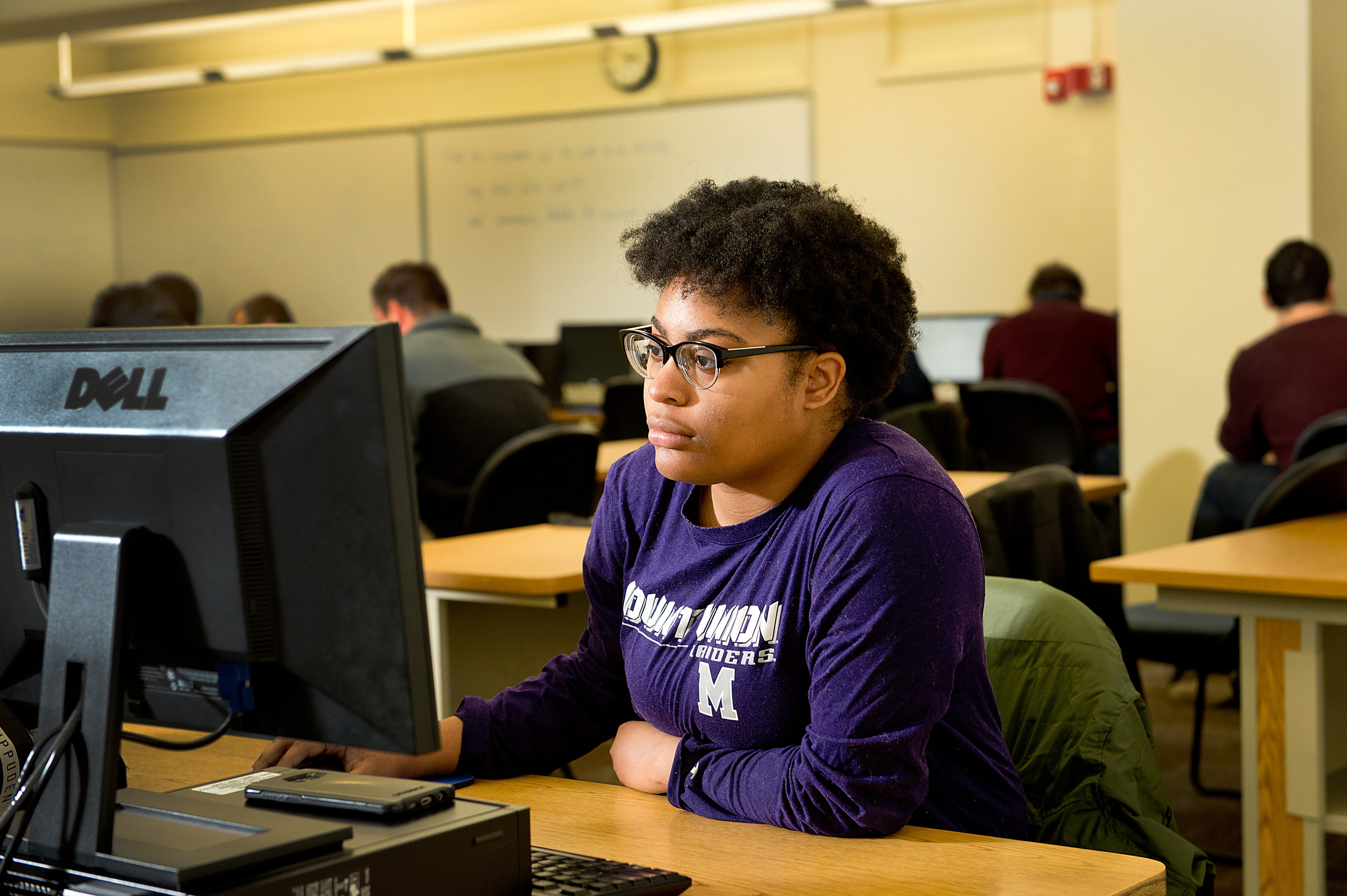 student sitting browsing on computer