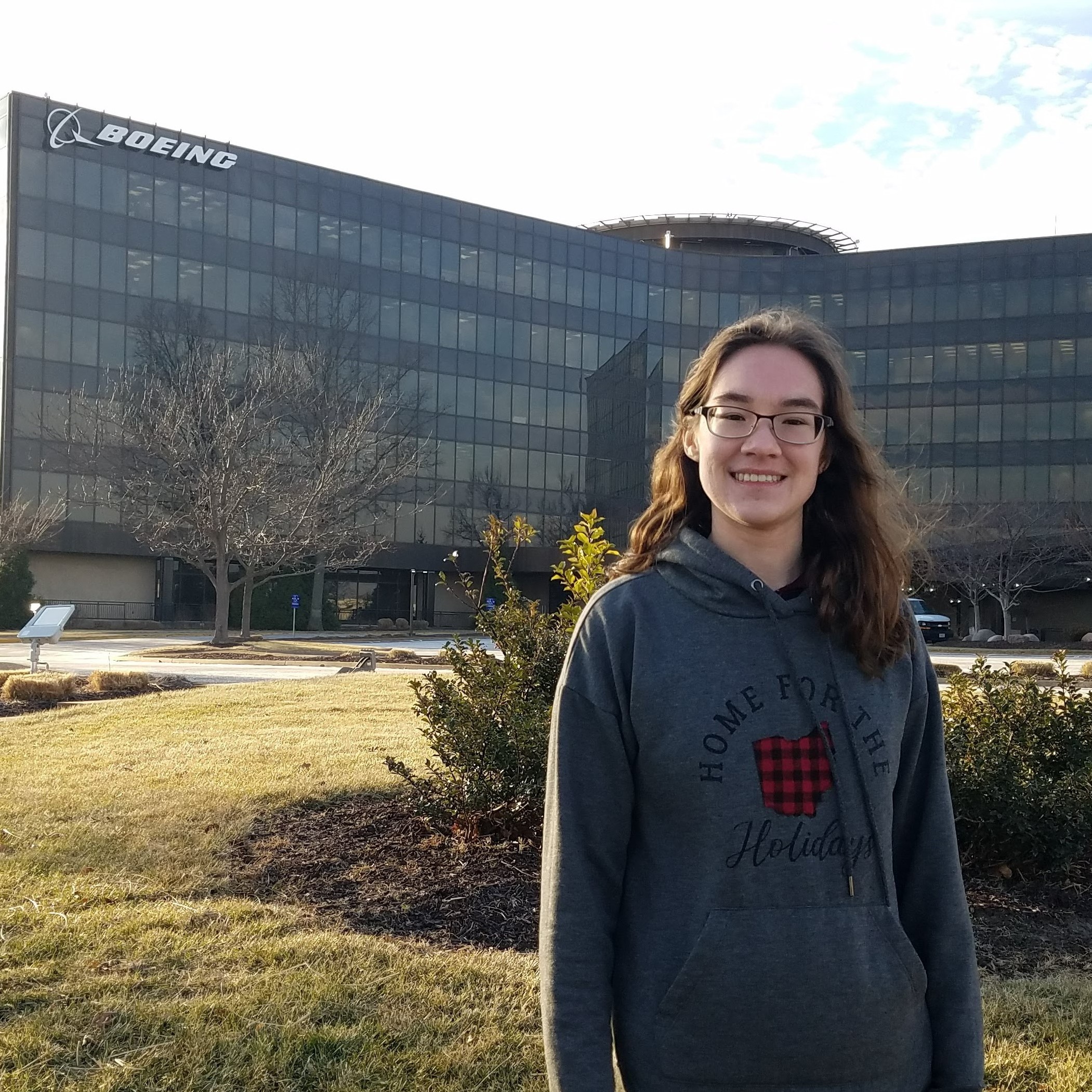 dana lucas standing in front of building