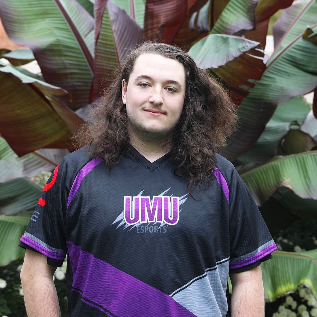 jake standish standing in front of plant