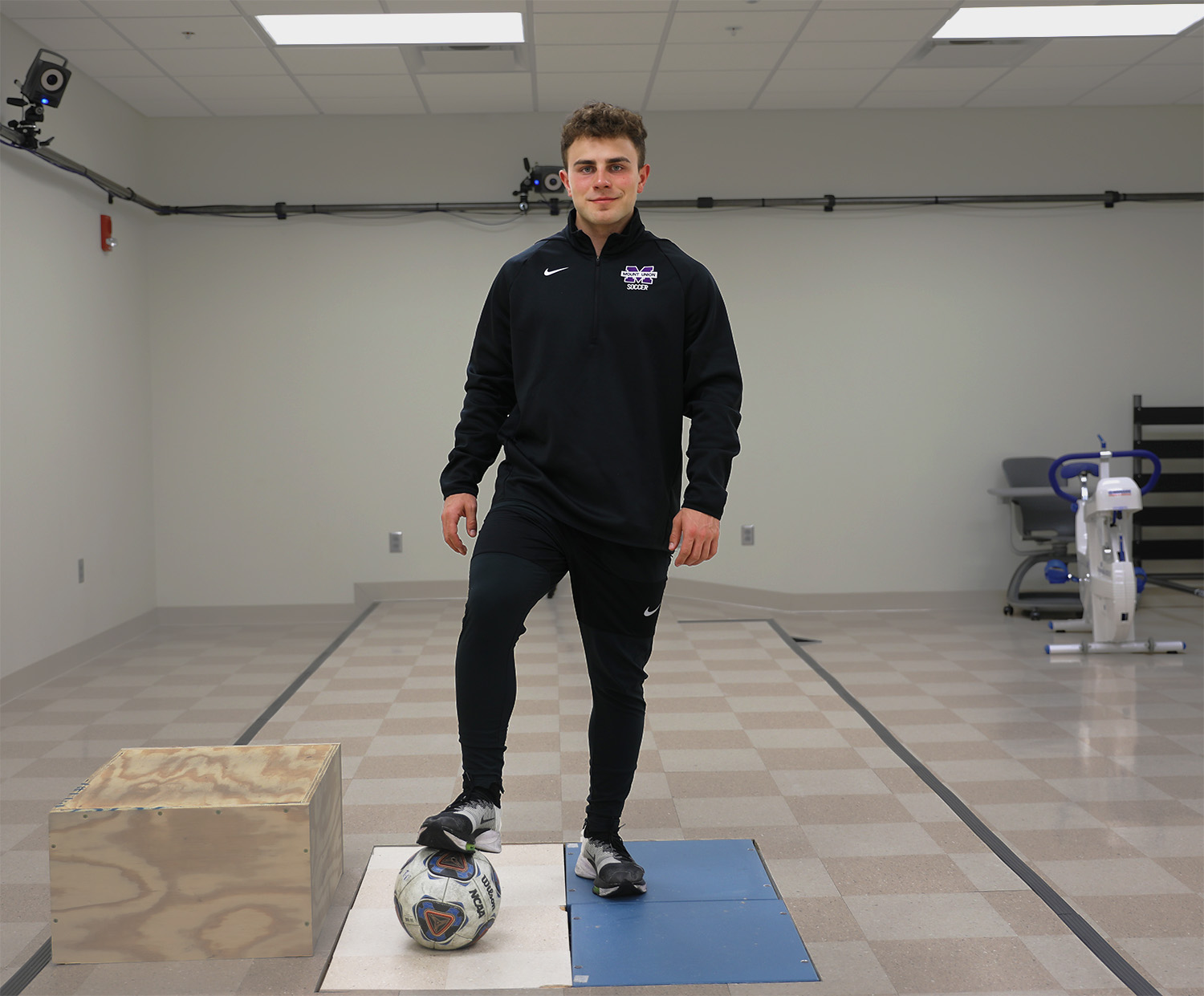 braydon lazzara standing on soccer ball in lab